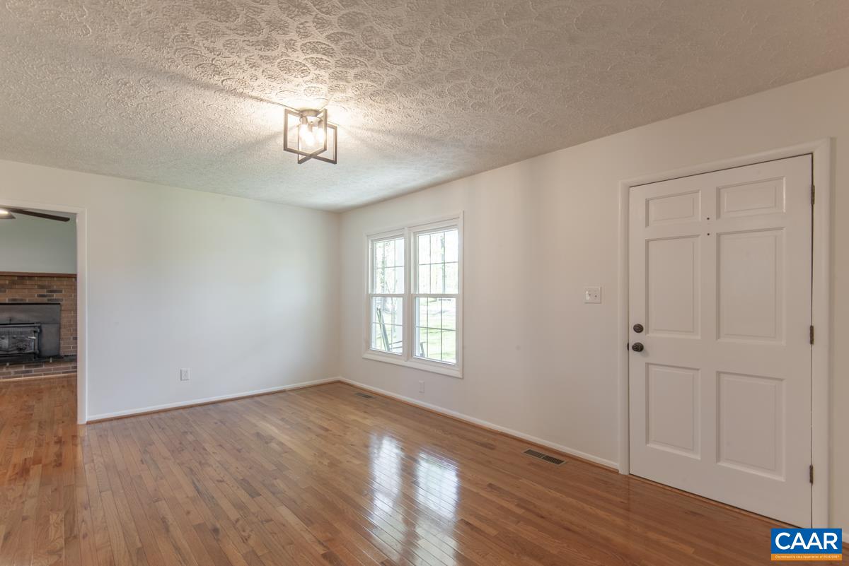 8882 James River Road Shipman, VA 22971 - Photo 7 of 50 a view of an empty room with wooden floor and a window