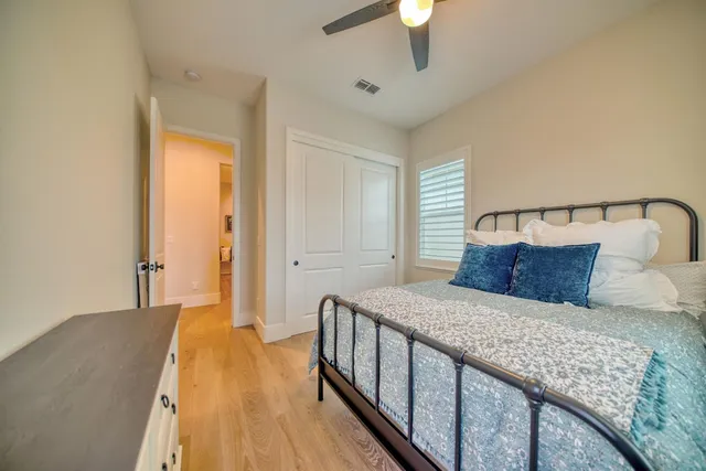 a bedroom with a bed and a chandelier