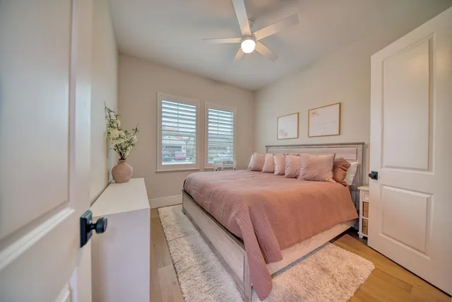 a bedroom with a large bed and a chandelier