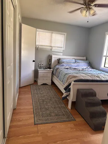 a bedroom with a large bed and a chandelier