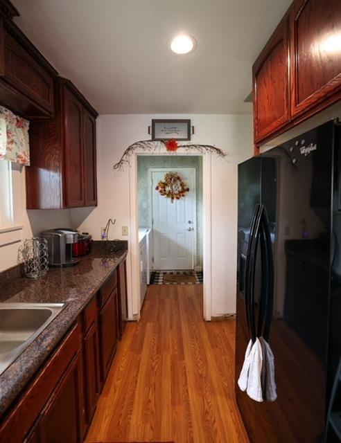 a kitchen with a refrigerator and a sink