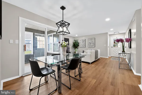 a view of a dining room with furniture wooden floor and chandelier