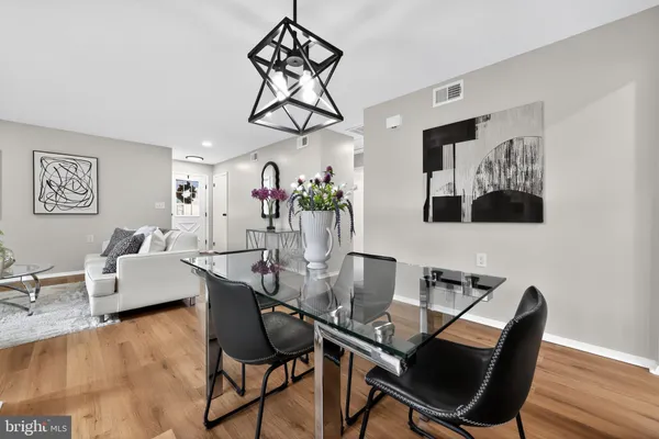 a view of a dining room with furniture wooden floor and chandelier