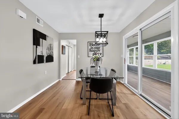 a view of a dining room with furniture wooden floor and chandelier