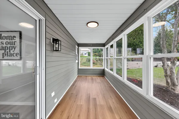 a view of a room with wooden floor and windows