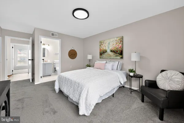 a spacious bedroom with a bed and a large mirror