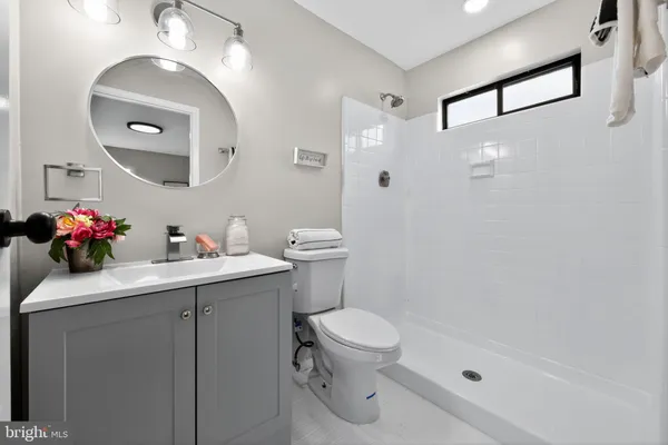 a bathroom with a sink toilet and a mirror