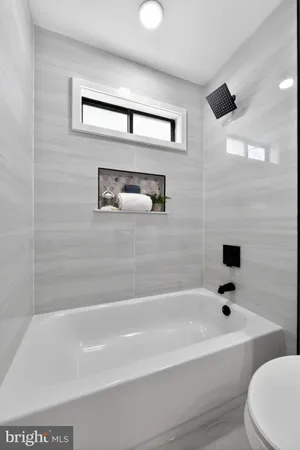 a bathroom with a bathtub and a shower