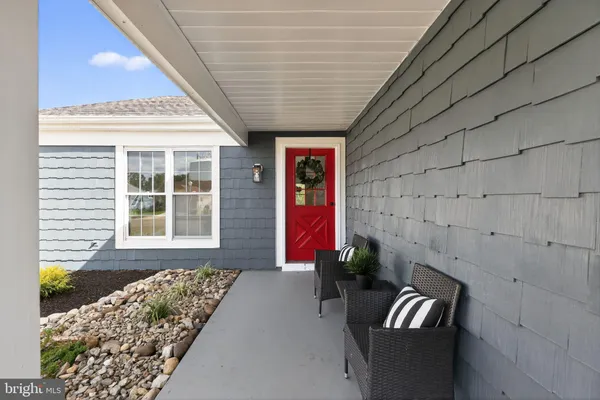 a front view of a house with outdoor seating