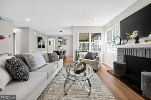 a living room with furniture a fireplace and a table