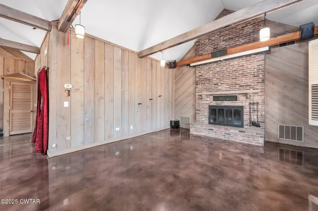 a large white kitchen with kitchen island a sink a counter top and stainless steel appliances