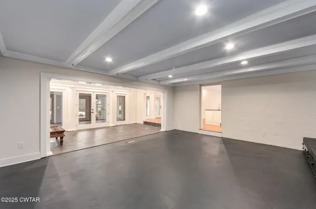 a bathroom with a double vanity sink and mirror with bathtub