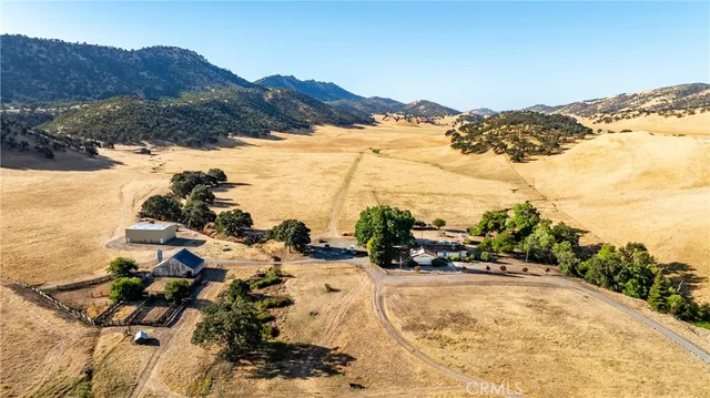 a view of a street with a house in the background