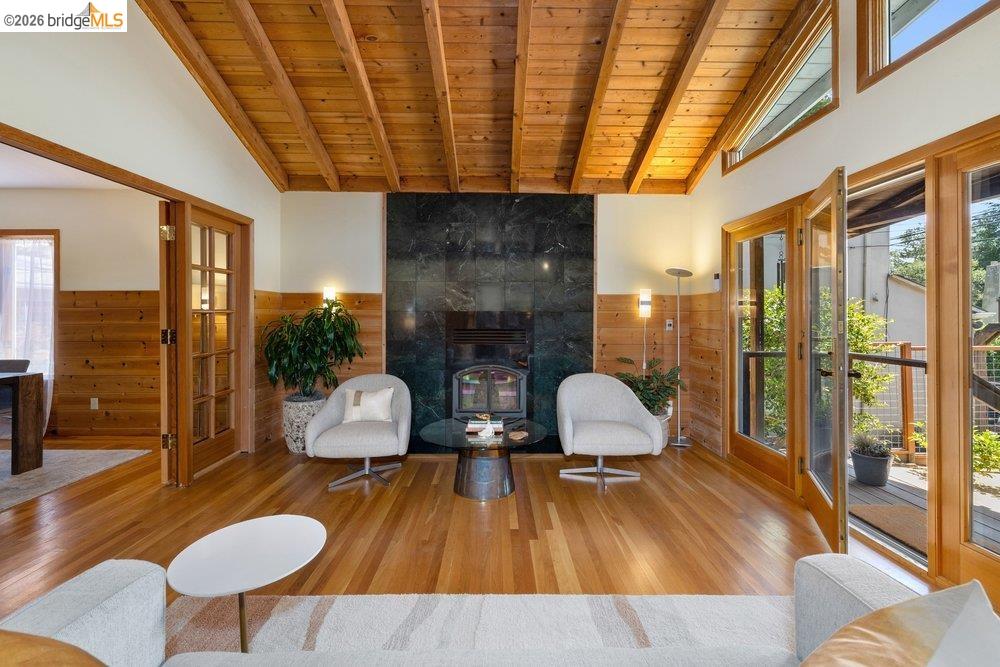 287 Purdue Avenue Kensington, CA 94708 - Photo 11 of 60 Vaulted wood plank ceiling over a living area with a dark stone fireplace surround