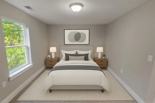 a bathroom with a granite countertop sink and white cabinets