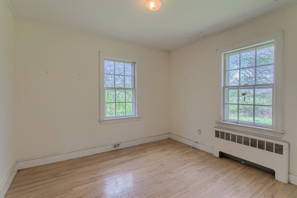 335 Ayer Road Harvard, MA 01451 - Photo 11 of 22 an empty room with wooden floor and windows