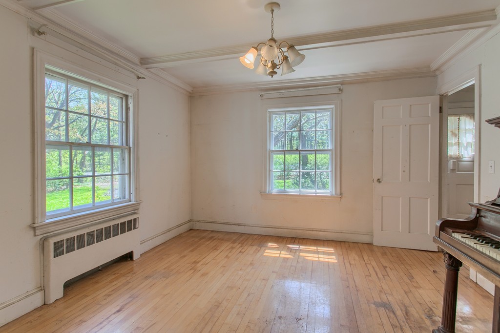 335 Ayer Road Harvard, MA 01451 - Photo 13 of 22 a view of an empty room with wooden floor and a window