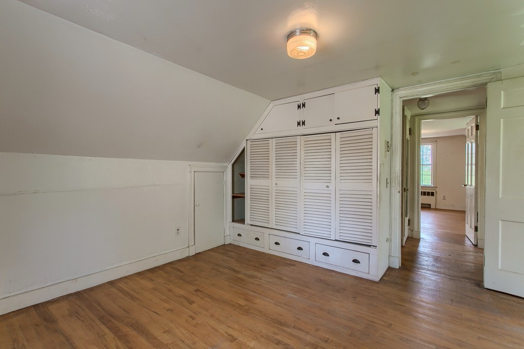 335 Ayer Road Harvard, MA 01451 - Photo 15 of 22 an empty room with wooden floor and windows