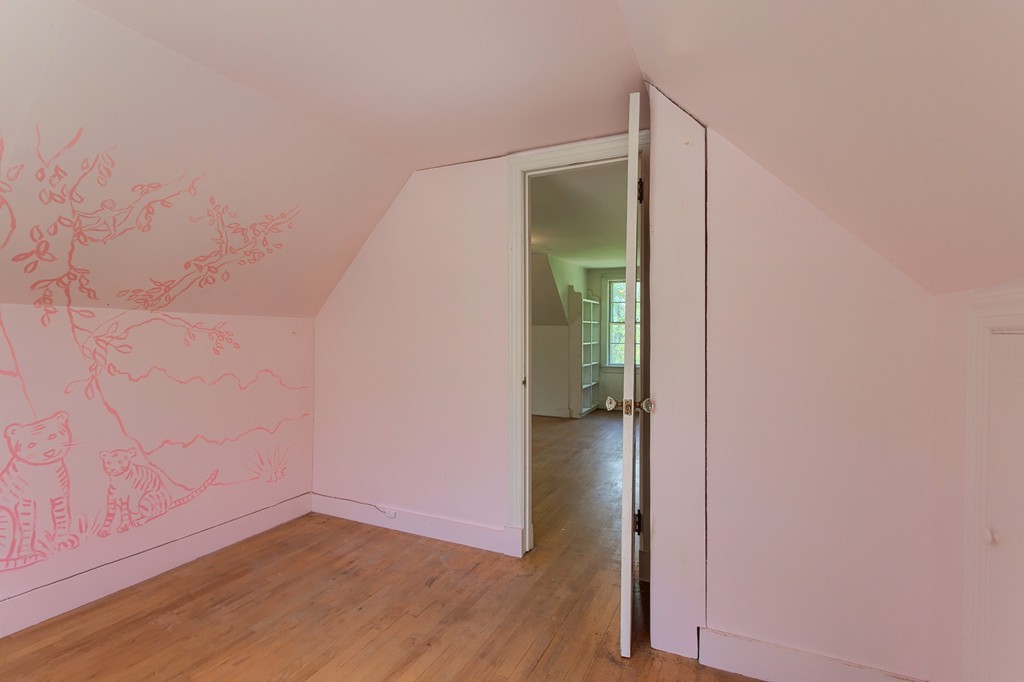 335 Ayer Road Harvard, MA 01451 - Photo 19 of 22 a view of an empty room with wooden floor and a bathroom