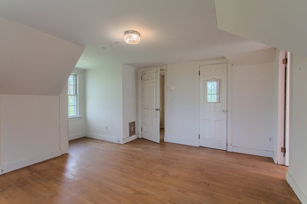 335 Ayer Road Harvard, MA 01451 - Photo 20 of 22 an empty room with wooden floor and windows