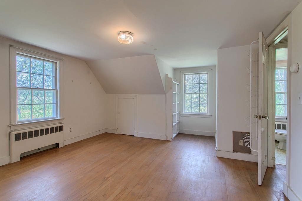 335 Ayer Road Harvard, MA 01451 - Photo 21 of 22 an empty room with wooden floor and windows