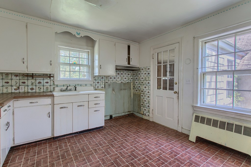 335 Ayer Road Harvard, MA 01451 - Photo 8 of 22 a kitchen that has a lot of cabinets in it and a window