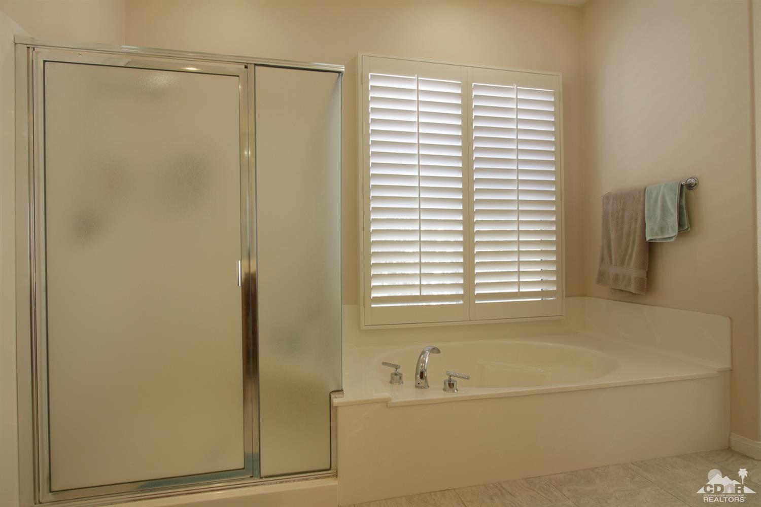 47 Provence Way Rancho Mirage, CA 92270 - Photo 15 of 30 a bathroom with a bathtub and a shower