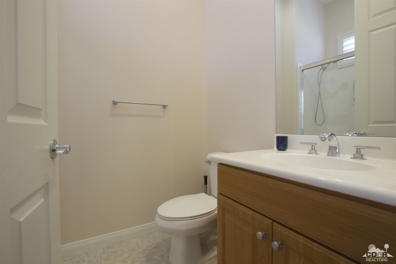 47 Provence Way Rancho Mirage, CA 92270 - Photo 17 of 30 a bathroom with a sink toilet and vanity