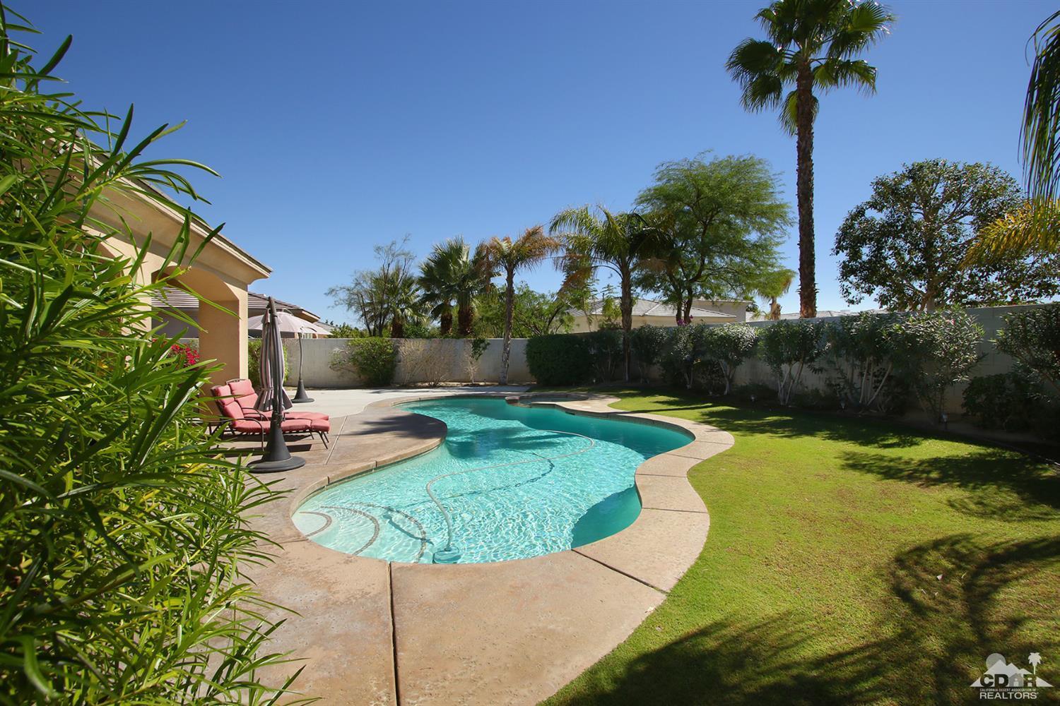 47 Provence Way Rancho Mirage, CA 92270 - Photo 27 of 30 a swimming pool with barbeque oven outdoor seating and yard