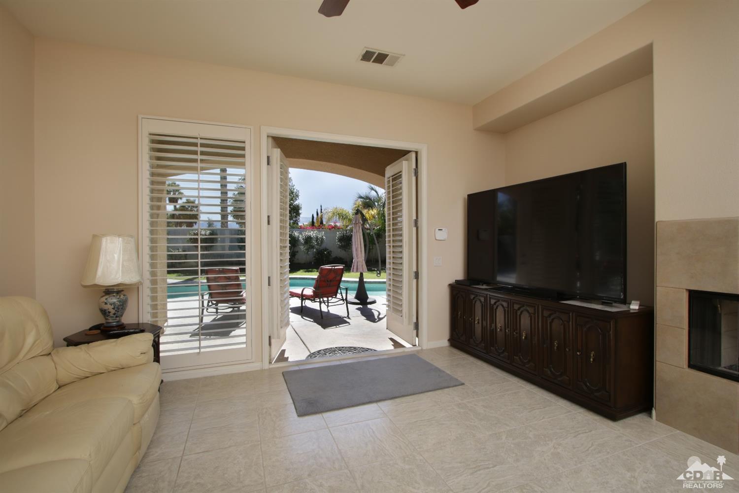 47 Provence Way Rancho Mirage, CA 92270 - Photo 8 of 30 a living room with furniture and a flat screen tv
