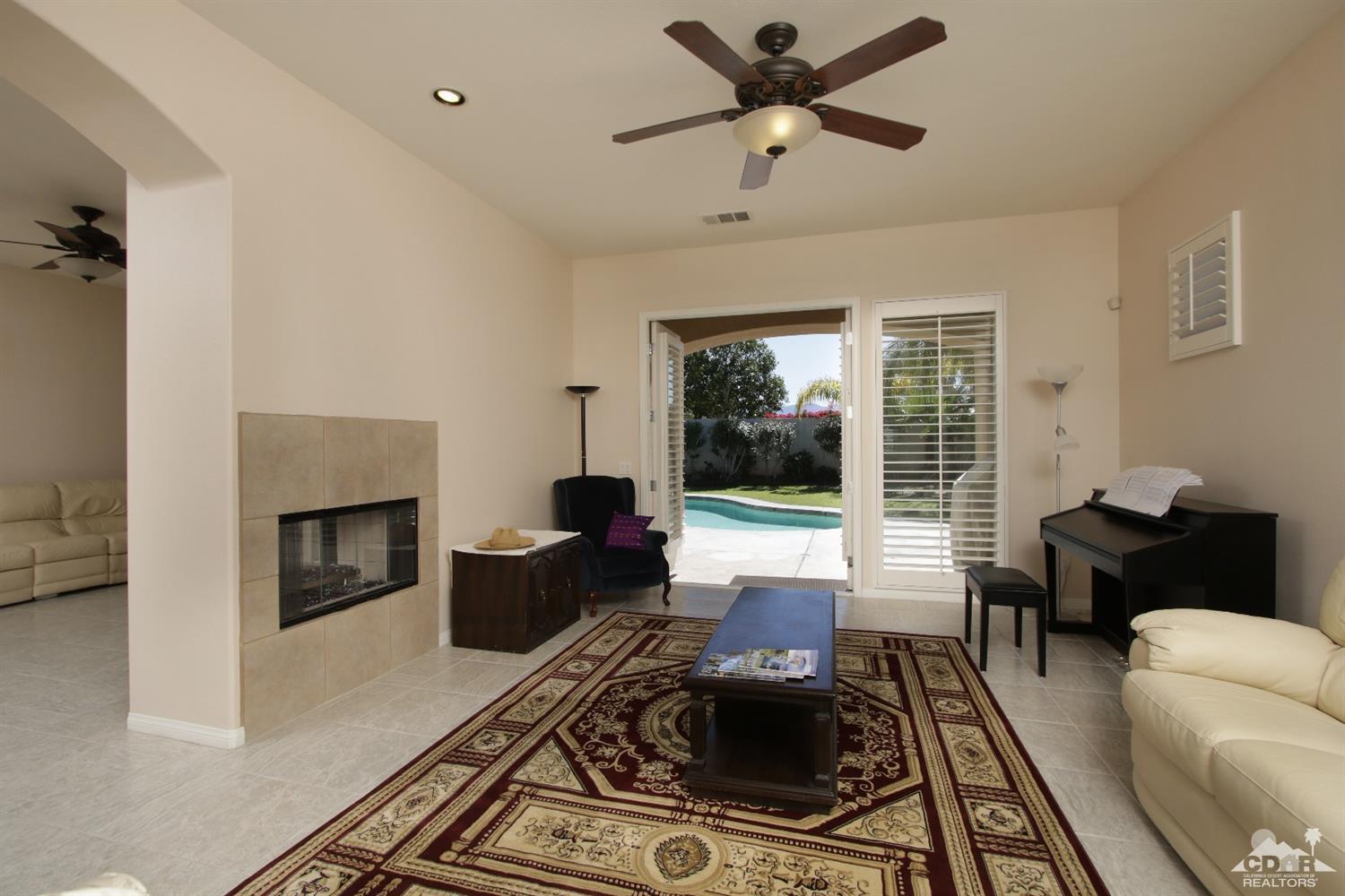 47 Provence Way Rancho Mirage, CA 92270 - Photo 10 of 30 a living room with furniture and a fireplace