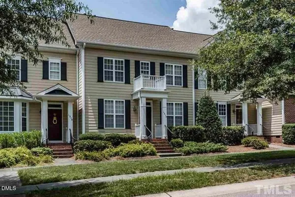 a front view of a house with a yard and outdoor seating
