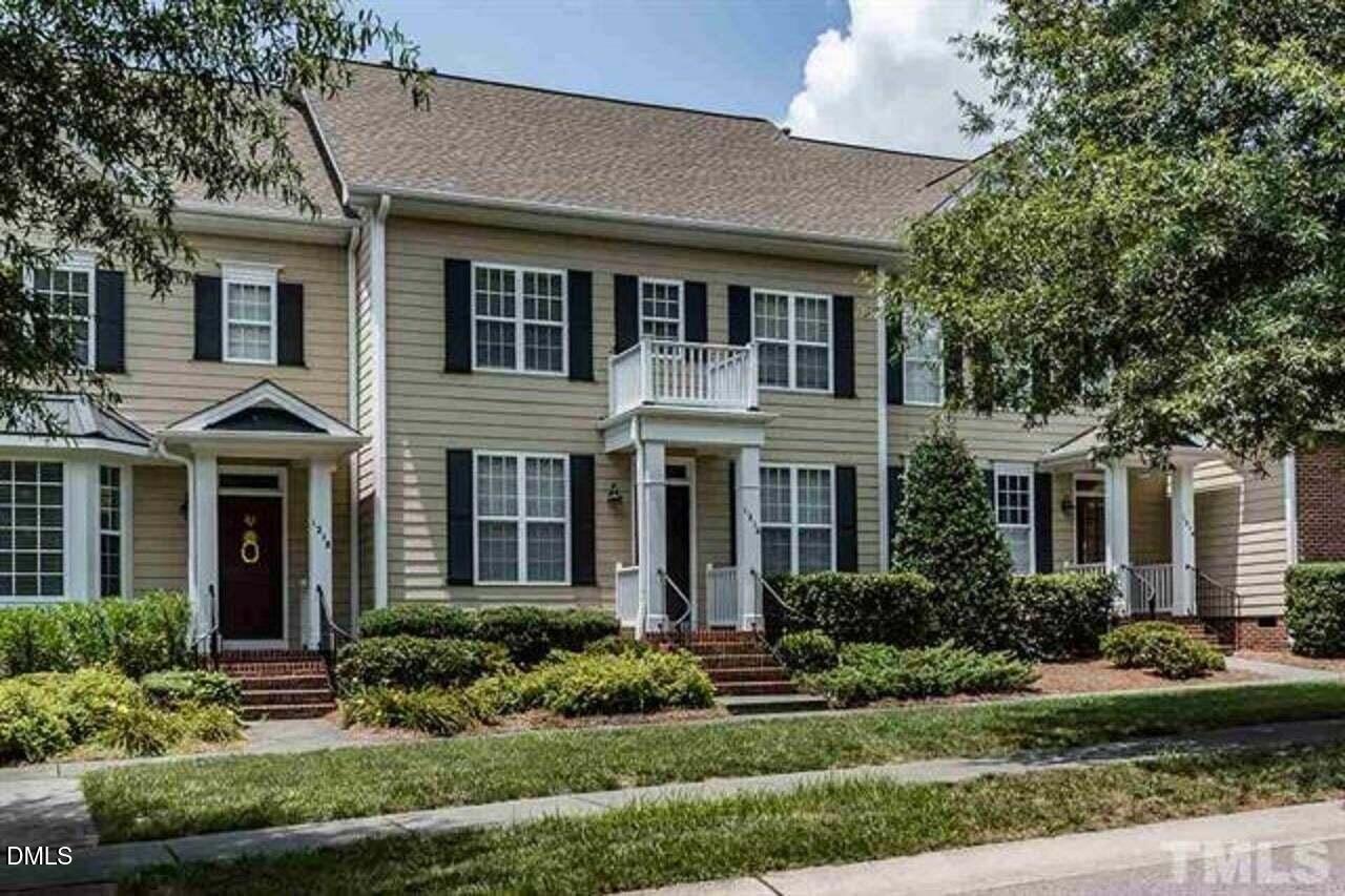 1216 Colonial Club Road Wake Forest, NC 27587 - Photo 1 of 26 a front view of a house with a yard and outdoor seating