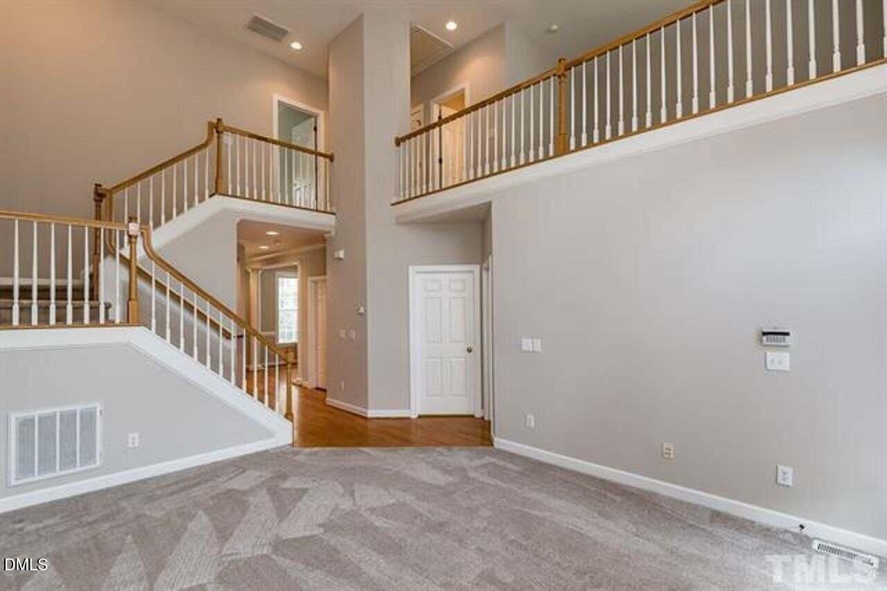 1216 Colonial Club Road Wake Forest, NC 27587 - Photo 14 of 26 a view of staircase with white walls and stairs