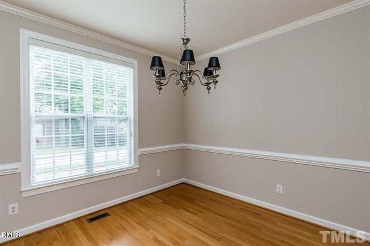 1216 Colonial Club Road Wake Forest, NC 27587 - Photo 5 of 26 a view of empty room with wooden floor and fan