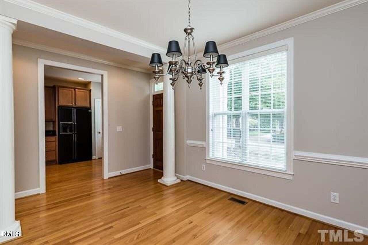 1216 Colonial Club Road Wake Forest, NC 27587 - Photo 6 of 26 a view of a livingroom with a window and wooden floor