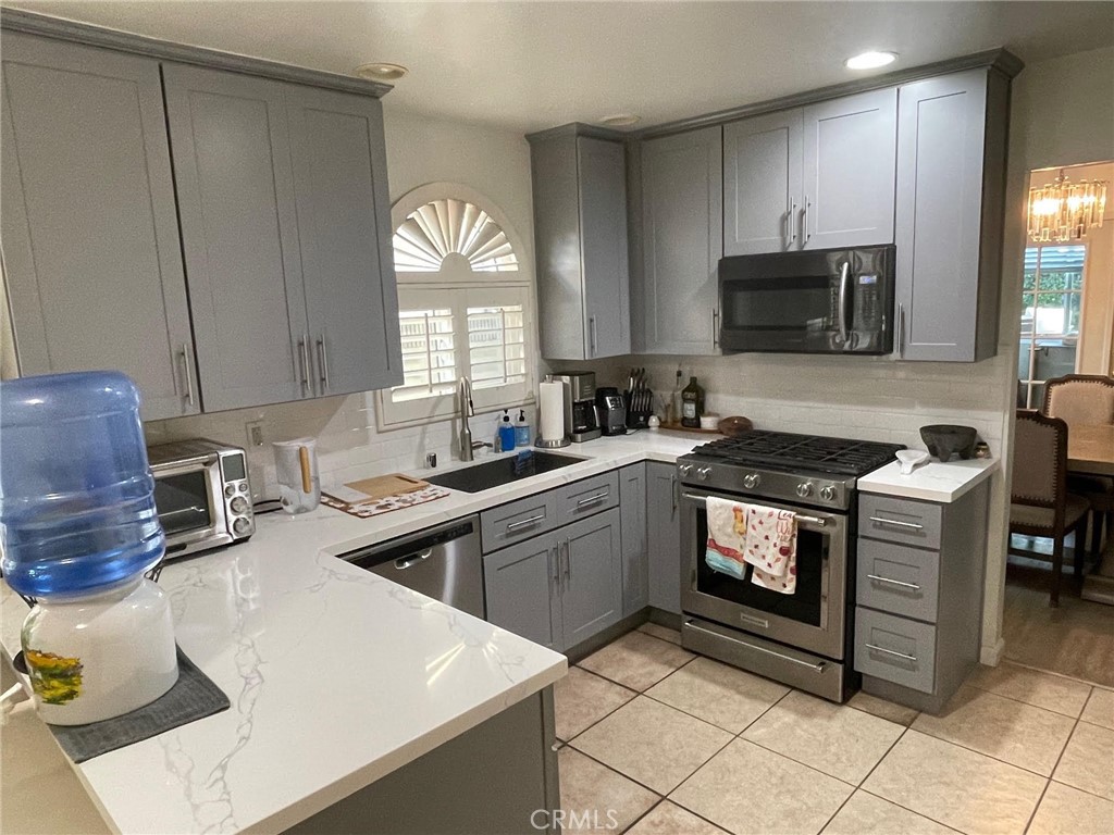840 East Meadbrook Street Carson, CA 90746 - Photo 13 of 32 a kitchen with a sink stove and microwave