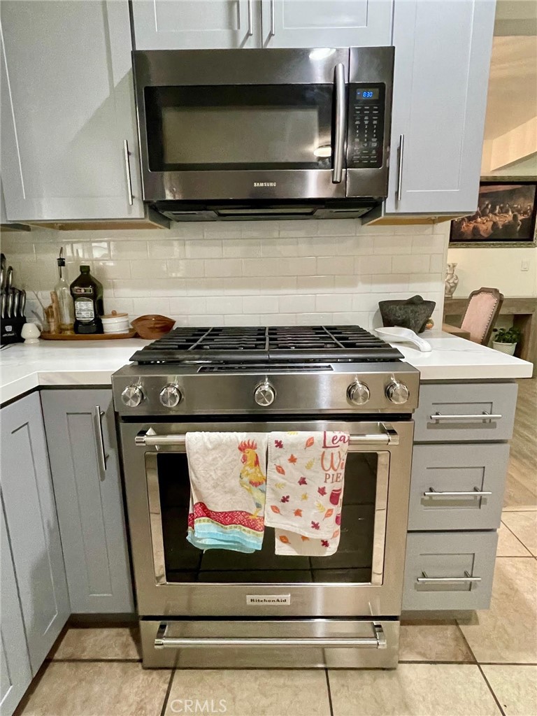 840 East Meadbrook Street Carson, CA 90746 - Photo 14 of 32 a kitchen with stainless steel appliances a stove a microwave and cabinets