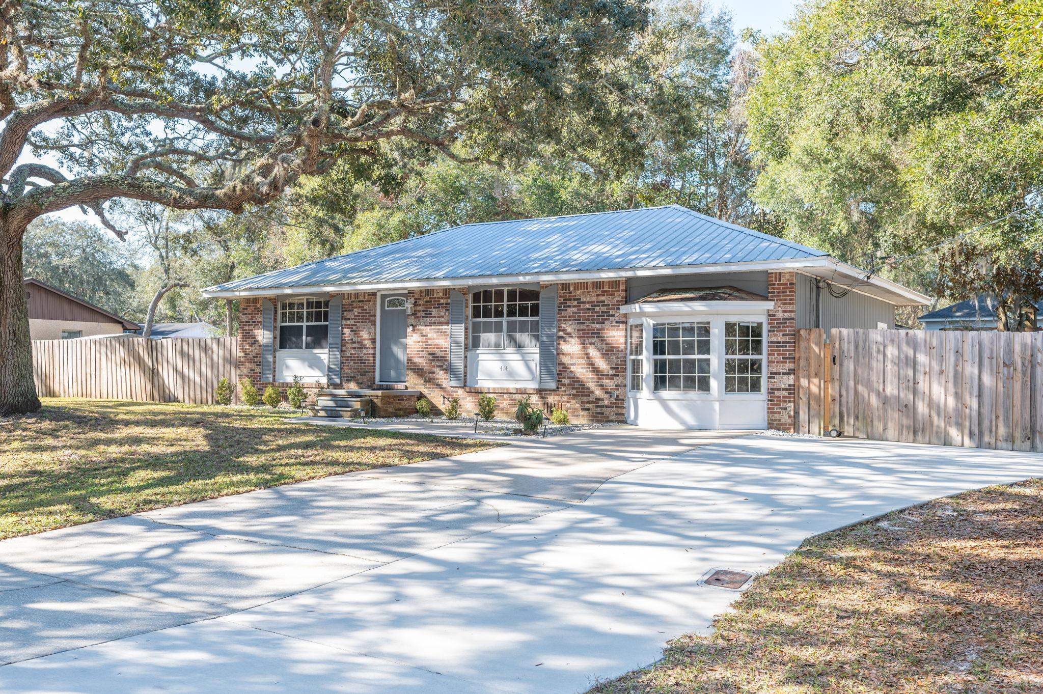 414 Jasmine Road St. Augustine, FL 32086 - Photo 3 of 30 a view of a house with a yard and sitting area