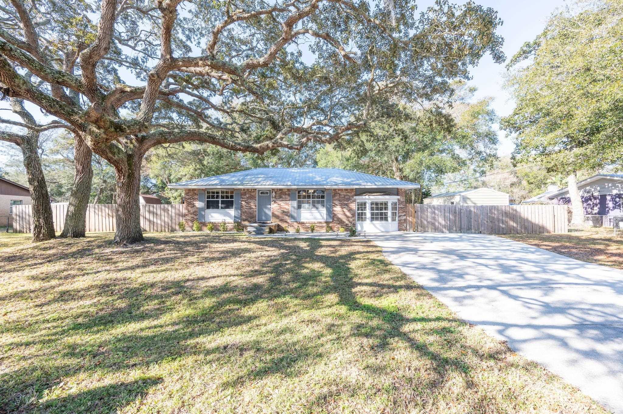 414 Jasmine Road St. Augustine, FL 32086 - Photo 4 of 30 a front view of a house with a yard and trees