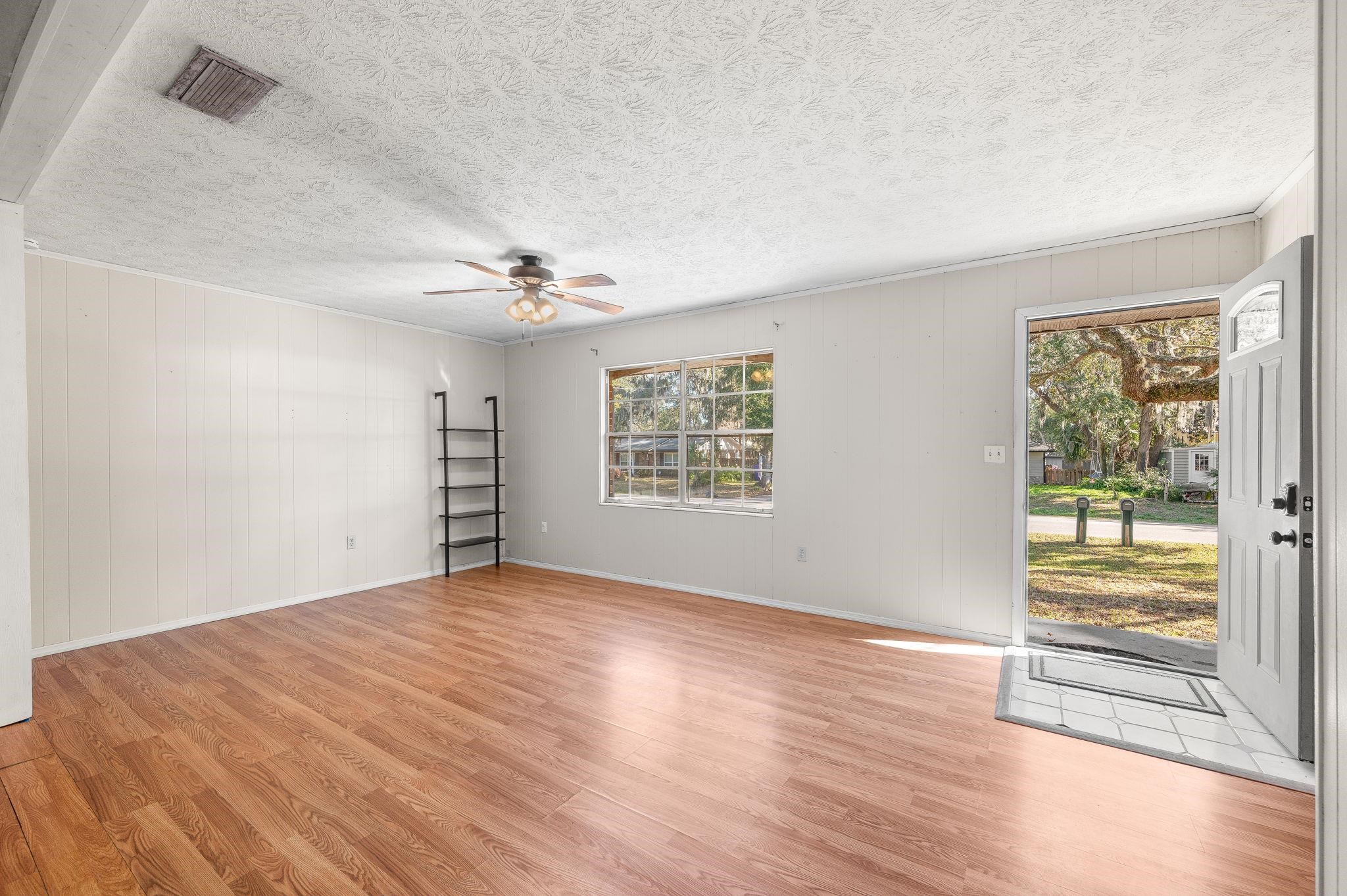 414 Jasmine Road St. Augustine, FL 32086 - Photo 5 of 30 wooden floor in an empty room with a window