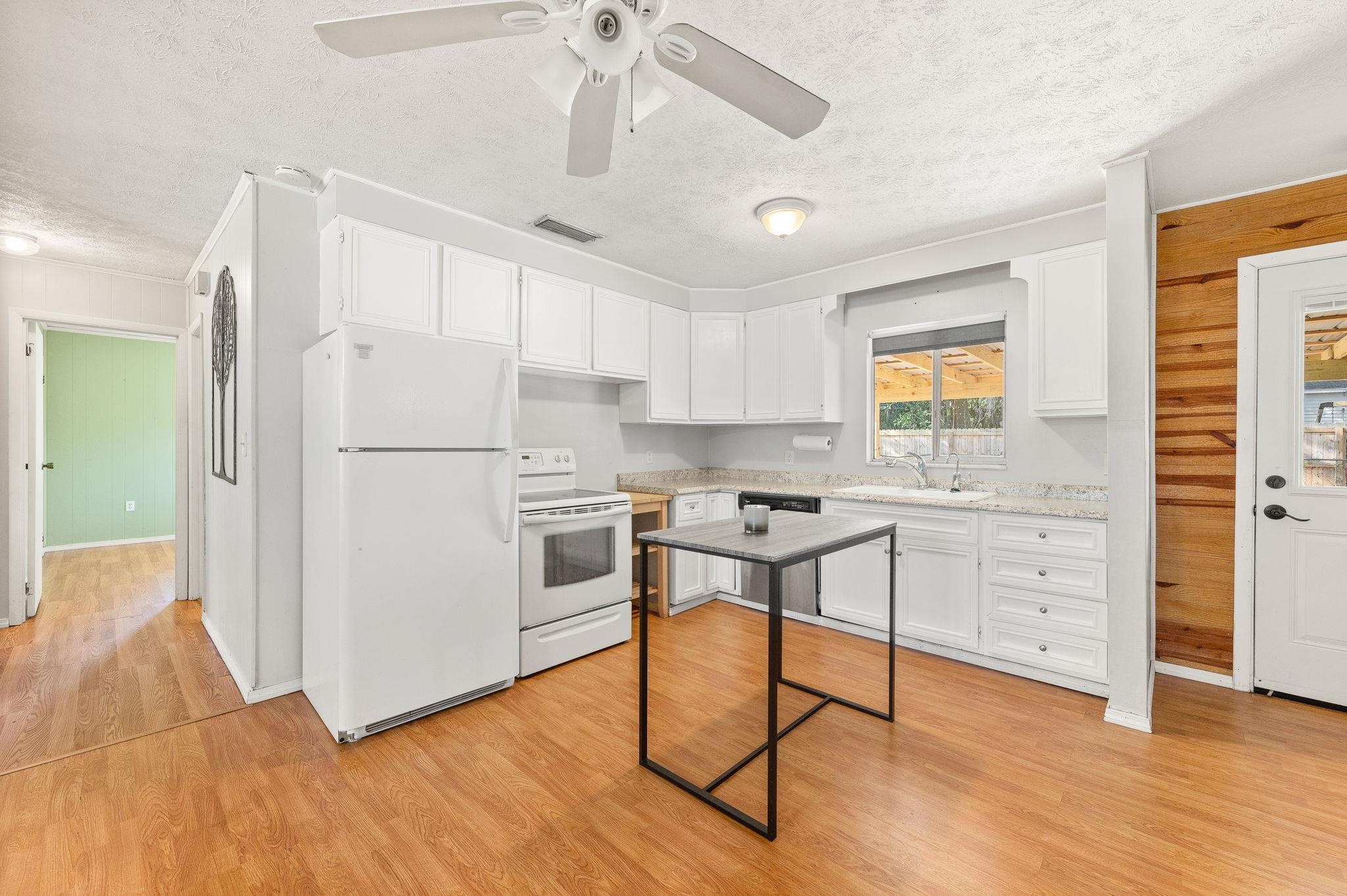 414 Jasmine Road St. Augustine, FL 32086 - Photo 10 of 30 a kitchen with white cabinets and stainless steel appliances