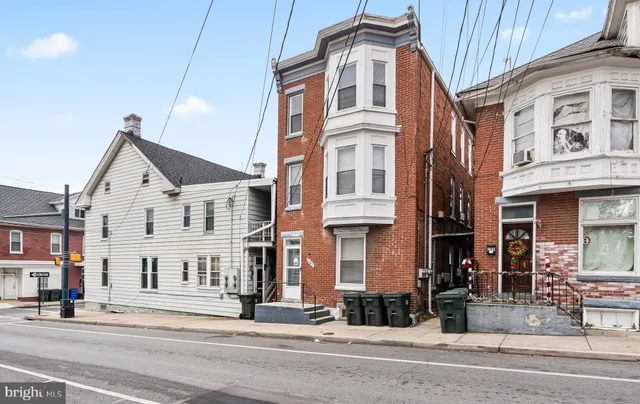 a view of a white building among the street