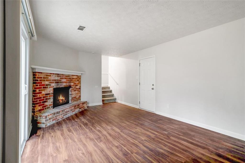 3723 Chimney Ridge Court Ellenwood, GA 30294 - Photo 14 of 33 a view of an empty room with wooden floor fireplace and a window