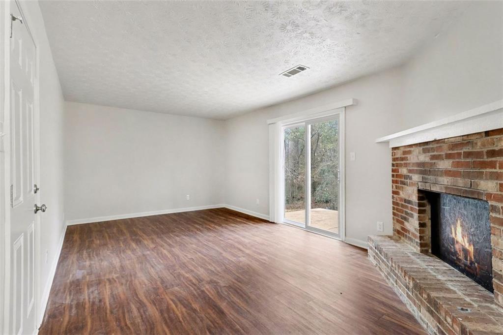 3723 Chimney Ridge Court Ellenwood, GA 30294 - Photo 15 of 33 a view of an empty room with wooden floor fireplace and a window