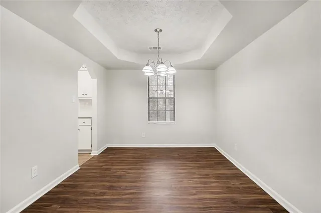 a view of a room with window and wooden floor