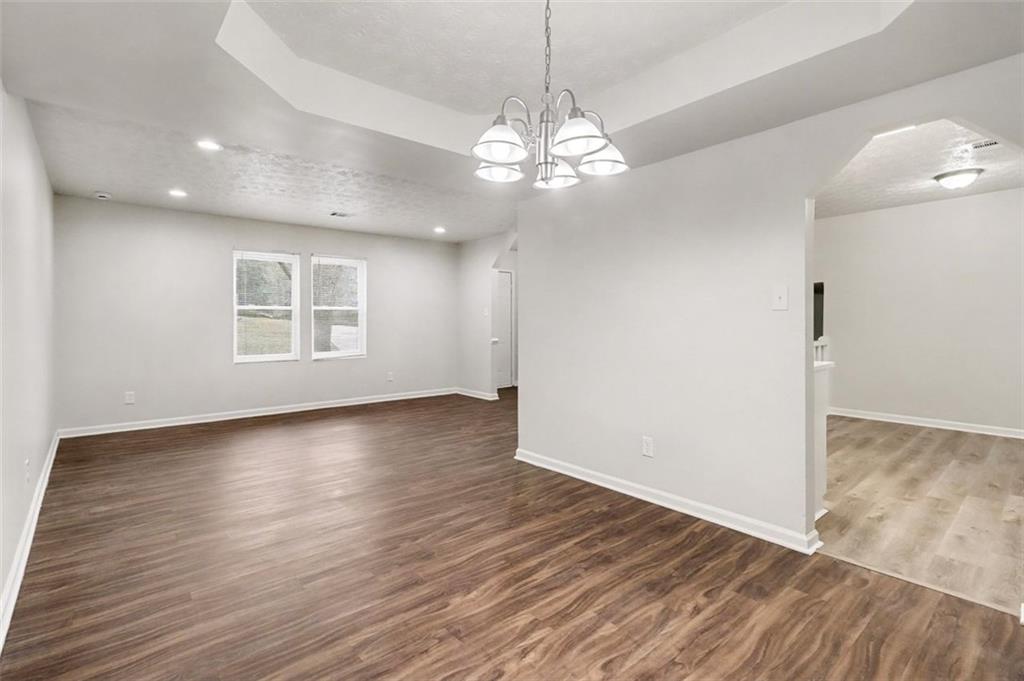 3723 Chimney Ridge Court Ellenwood, GA 30294 - Photo 7 of 33 an empty room with wooden floor and windows