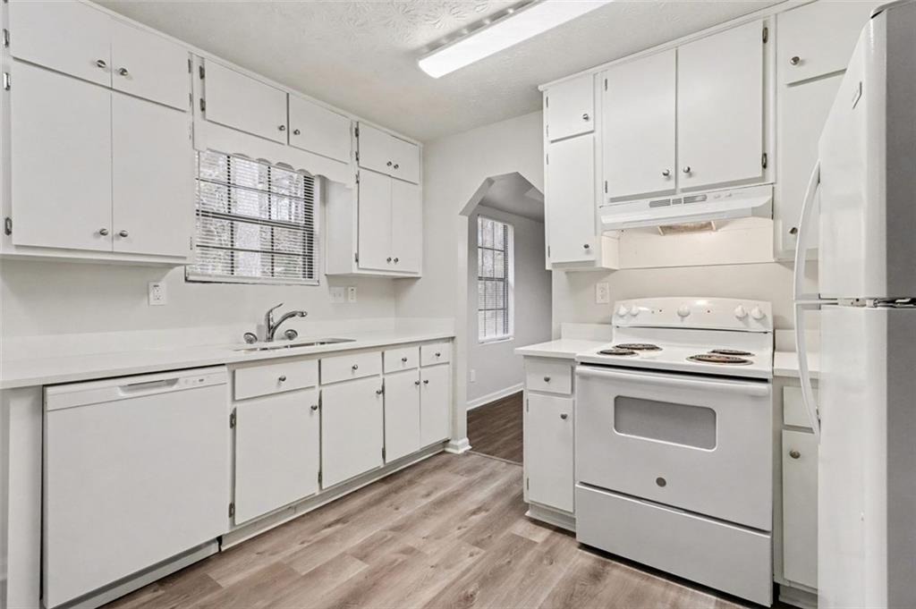 3723 Chimney Ridge Court Ellenwood, GA 30294 - Photo 10 of 33 a kitchen with granite countertop white cabinets and white appliances