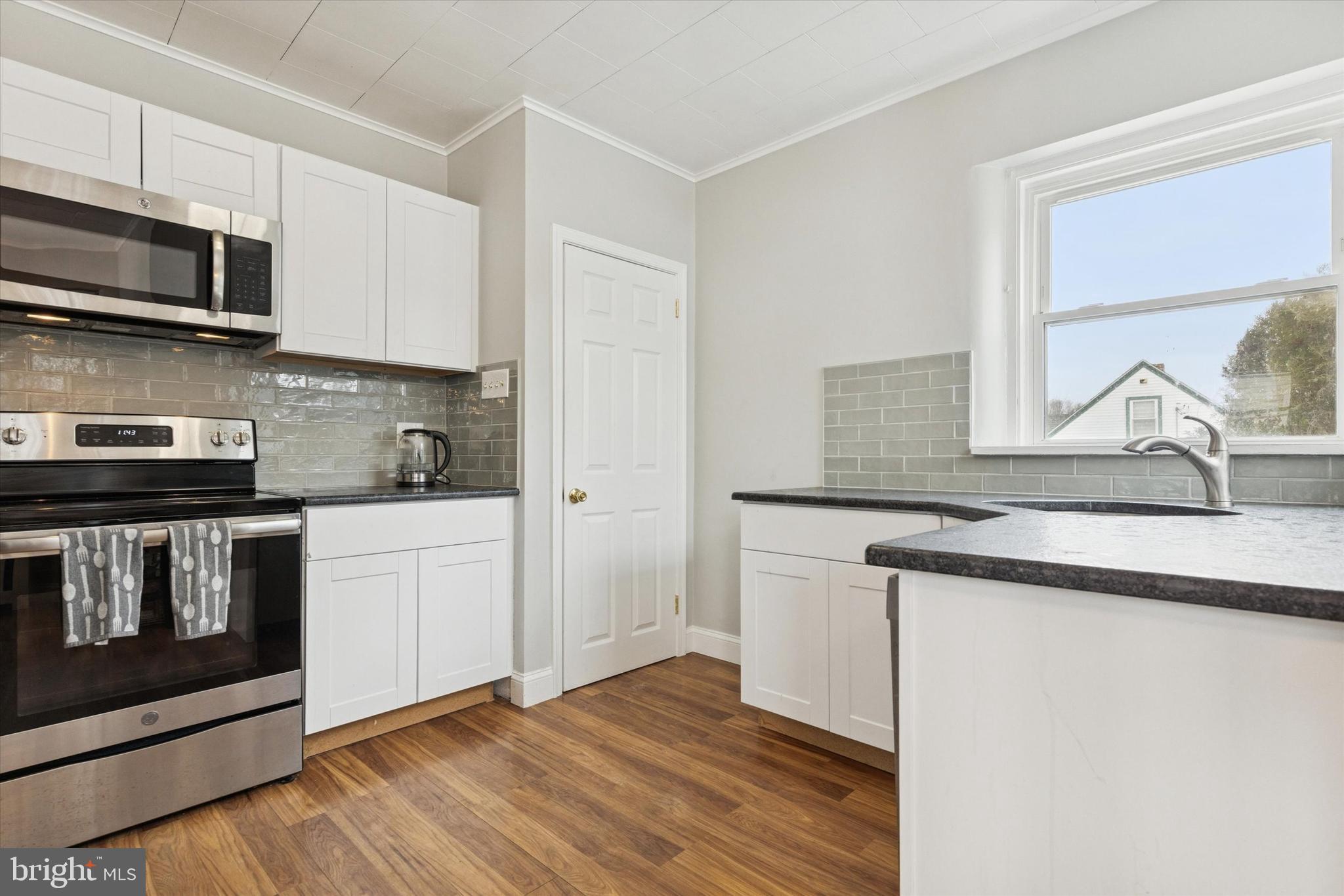 1185 Kepler Road Pottstown, PA 19464 - Photo 4 of 21 a kitchen with stainless steel appliances granite countertop a sink stove and microwave