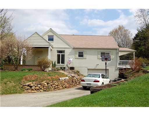 676 Donohoe Road Latrobe, PA 15650 - Photo 11 of 11 Exterior Front. Side view of driveway entrance and garage with plantings surrounding.
